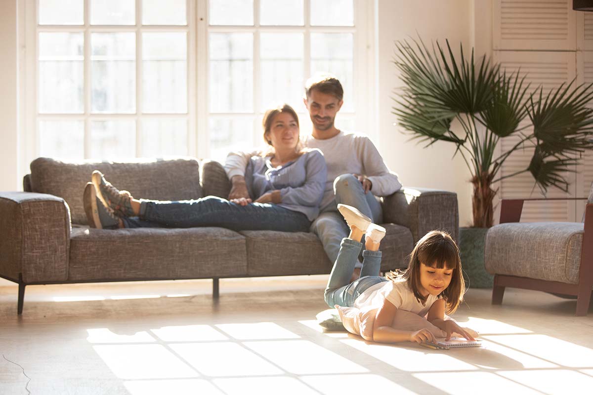 Happy parents relaxing on couch