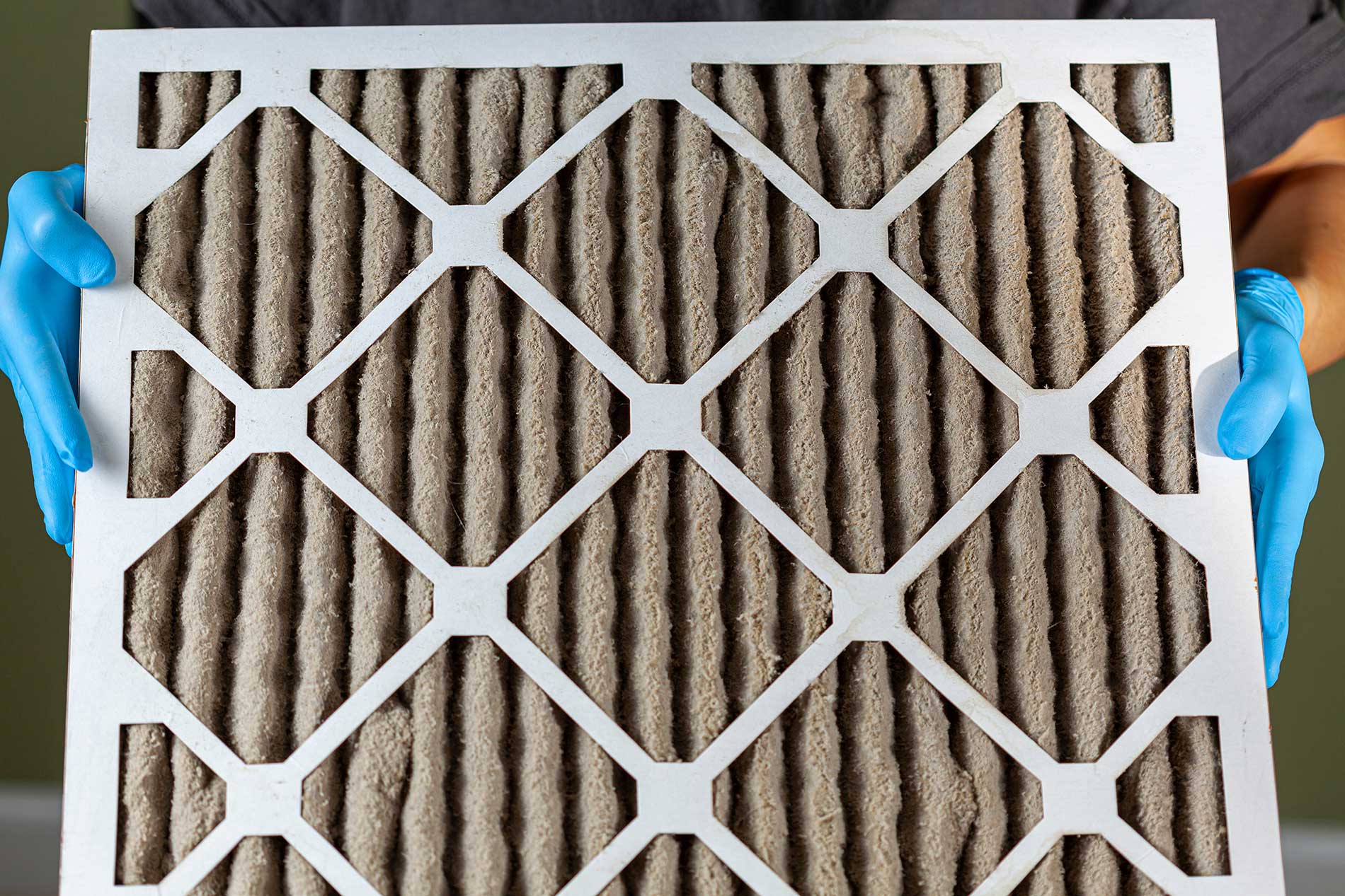 a furnace filter full of dust and over used