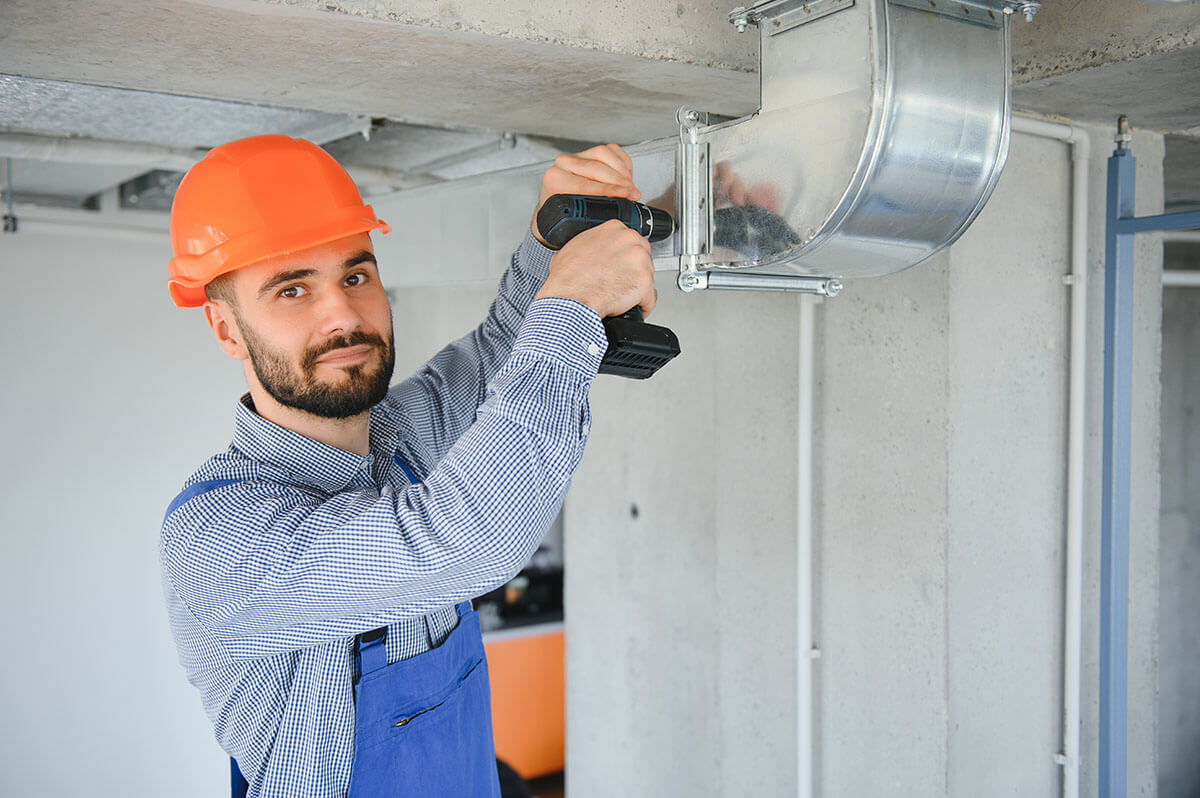 hvac worker install ducted pipe system